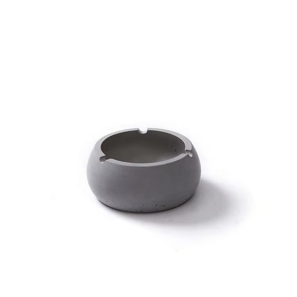 Minimalist gray concrete ashtray top view, isolated on white background