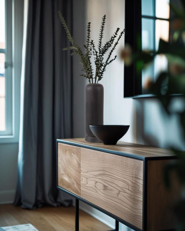 Wooden entry table with decorative vases in a room with curtains and a television.