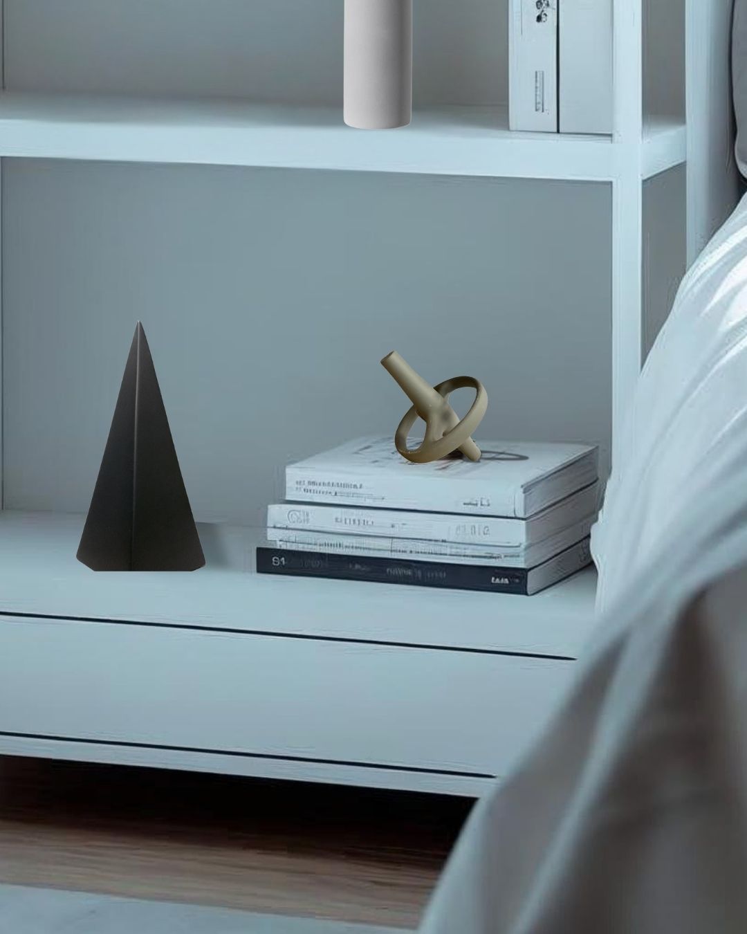 gray decorative acccent on a bookcase with books and sculptures