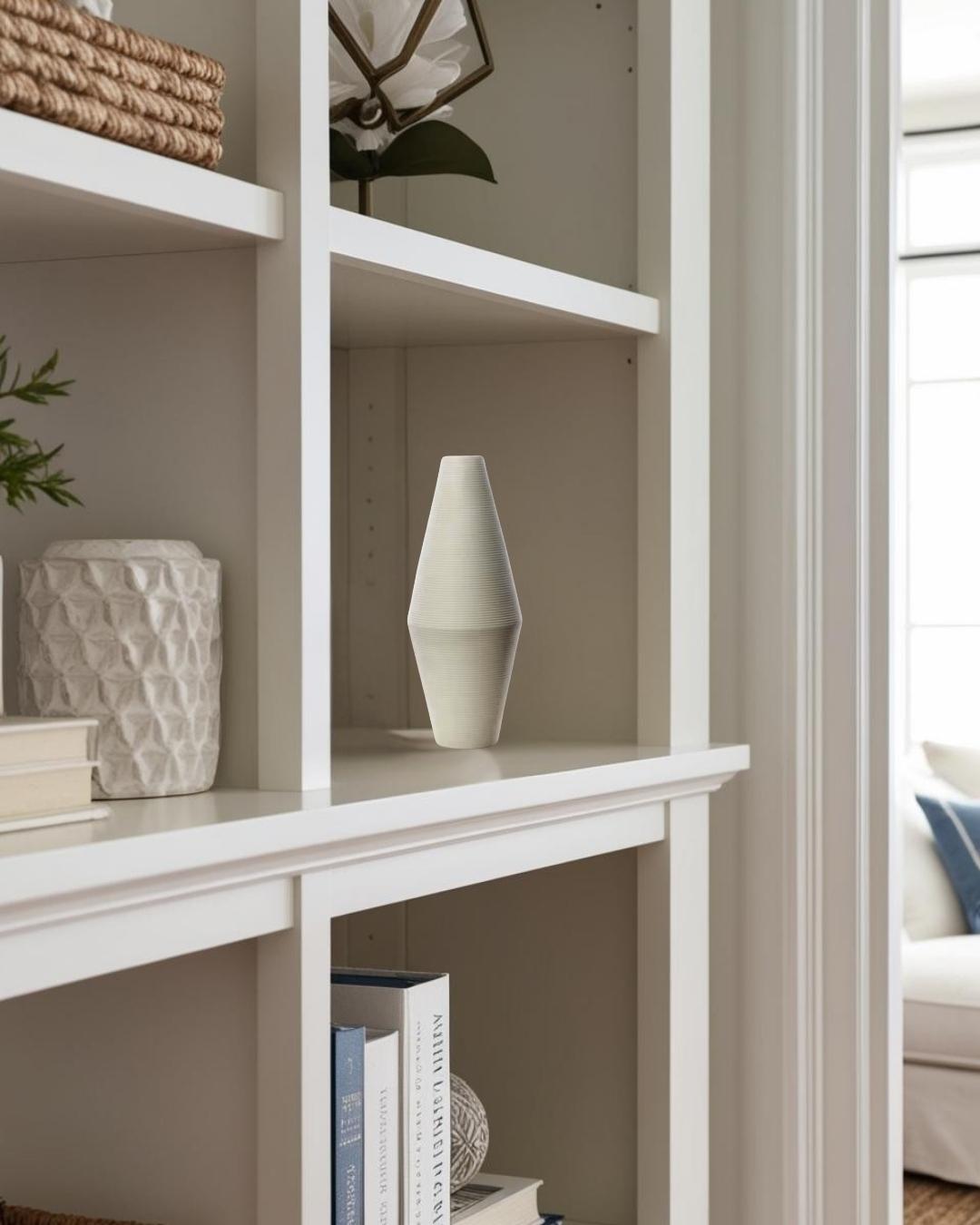 White vase and sculpture on bookcase in a compact farmhouse room