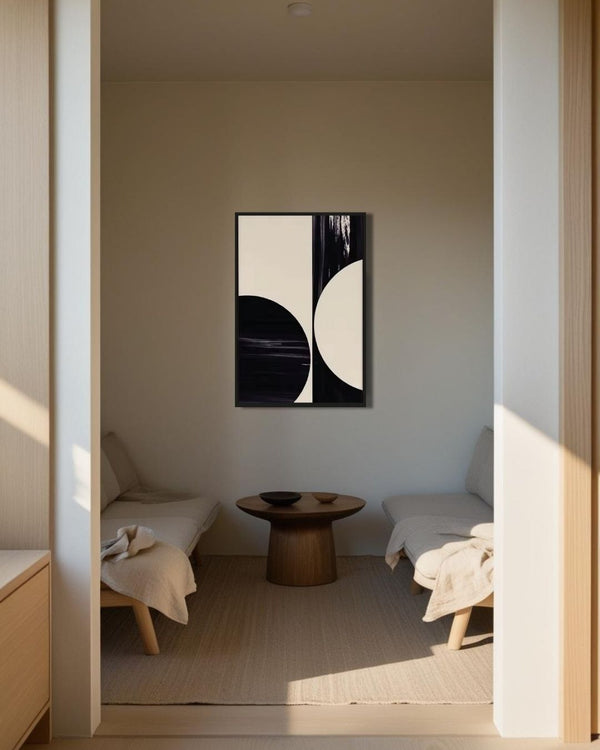 Black and white Japandi artwork hanging above a modern cozy seating nook with wooden accents