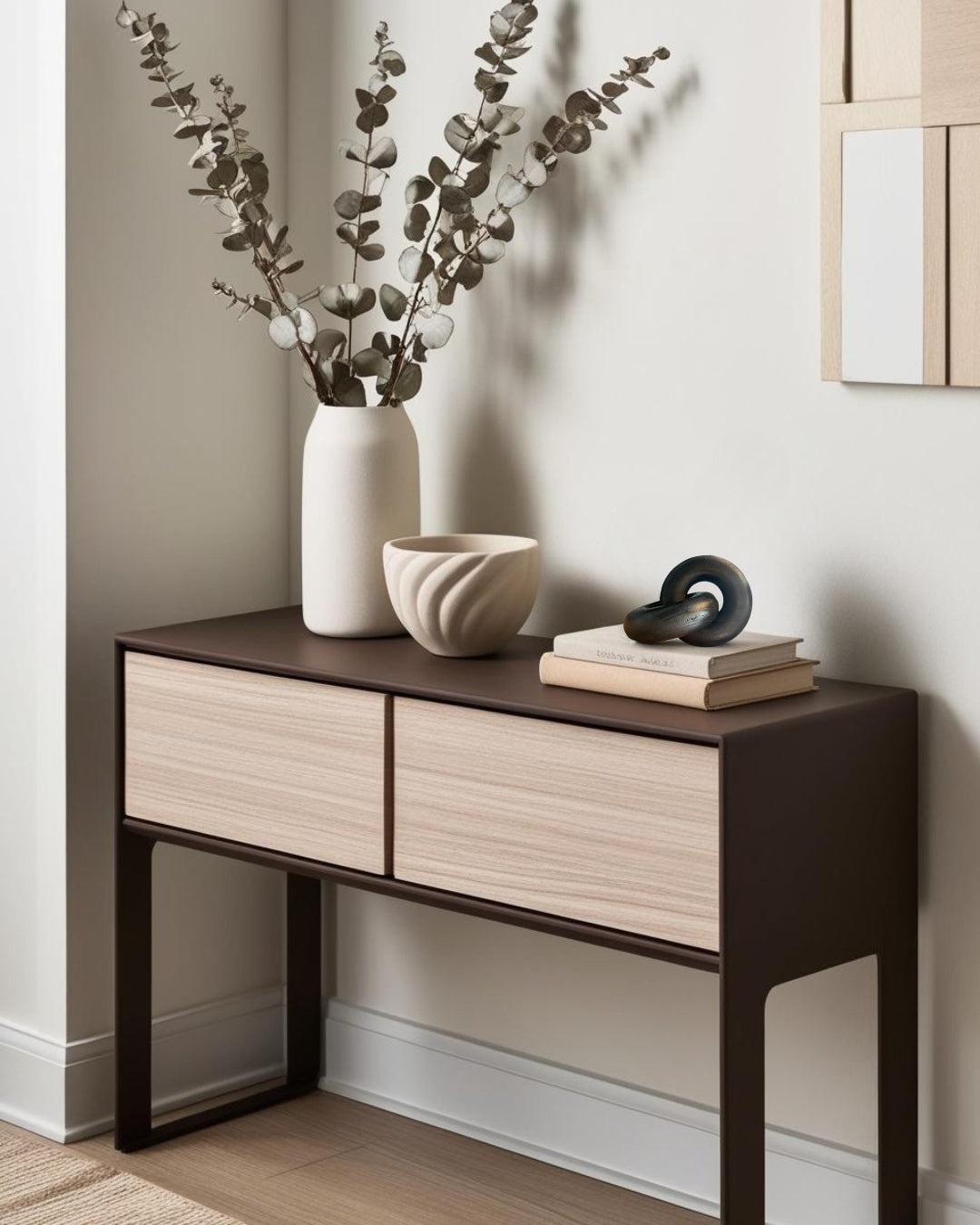 Black geometric knot decor on wood entry table with branches in vase in farmhouse entry