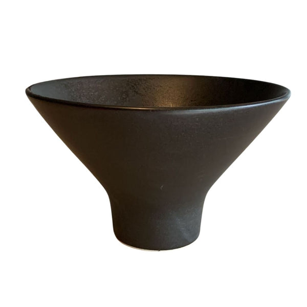 Front angled view of black decorative porcelain bowl isolated on white background