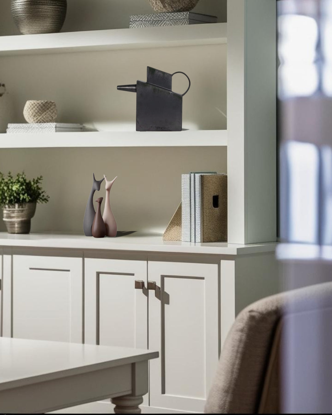 Black rectangular ceramic decorative pitcher on a white bookcase in a farmhouse style home office
