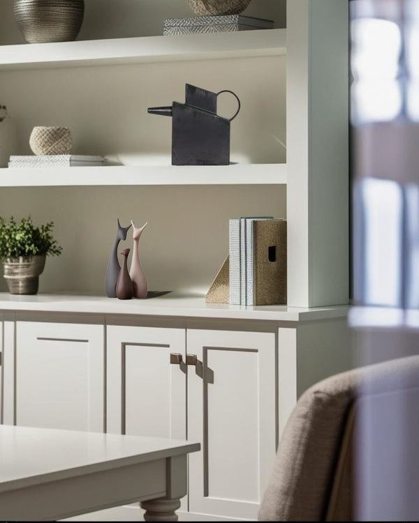 Black rectangular ceramic decorative pitcher on a white built-in shelf in a farmhouse style home office