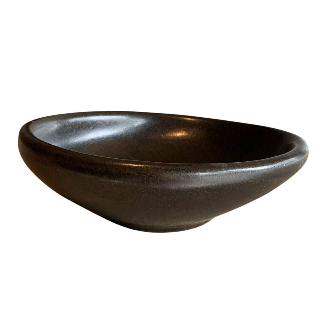Side view of bold black sculptural porcelain decorative bowl isolated on white background_2