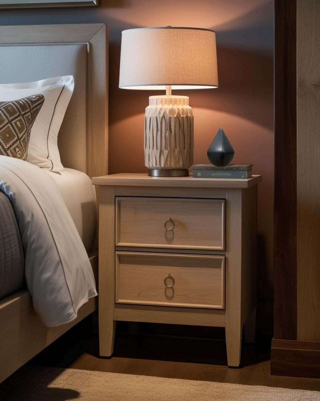 black geometrc accent on nightstand in a compact transitional bedroom

