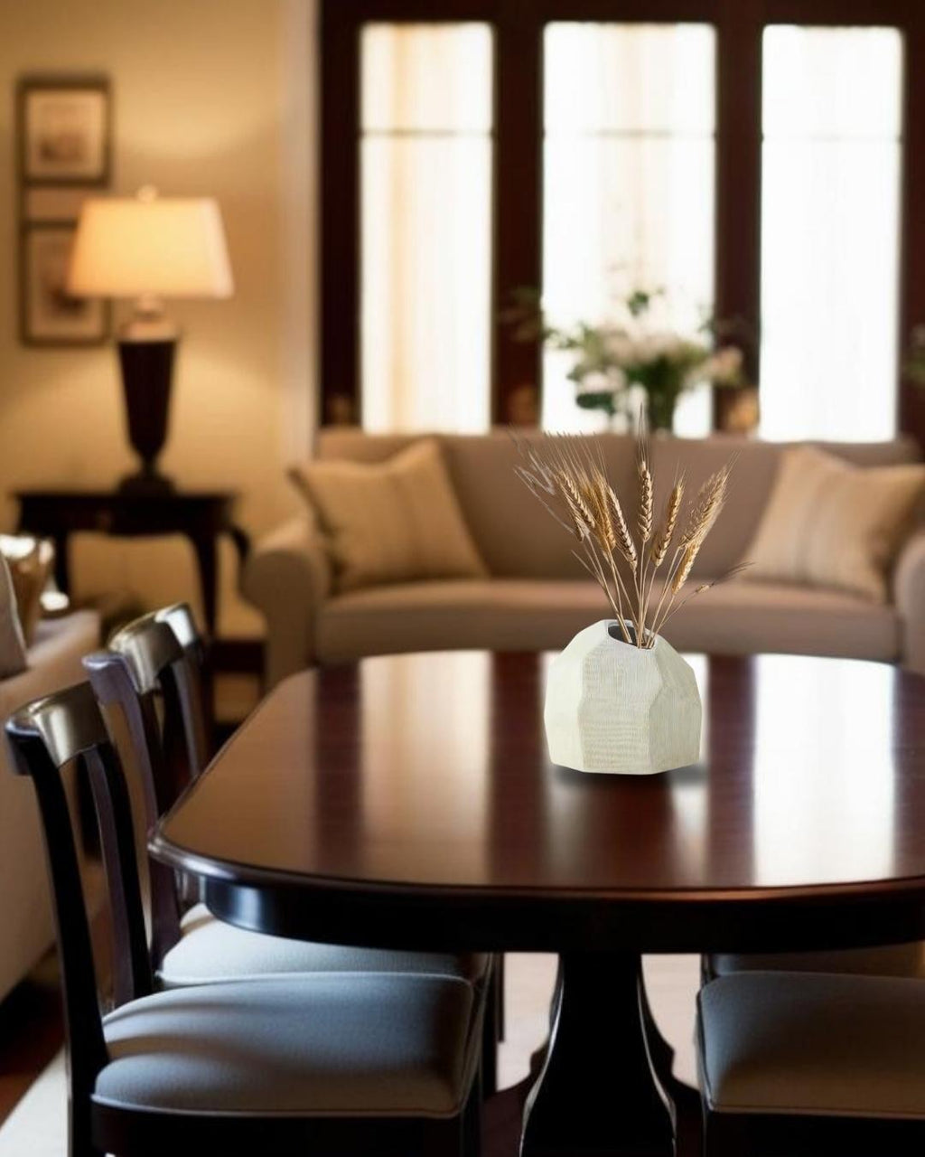 Bold white ceramic sculptural vase on dining table in a farmhouse style living room

