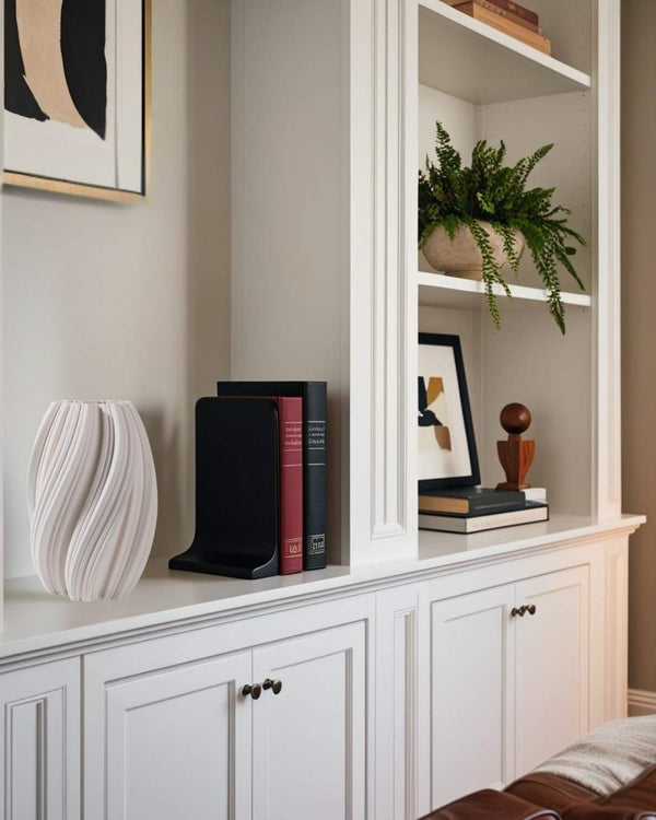Geometric 3D printed vase displayed on a white built-in shelf in a minimalist lving room