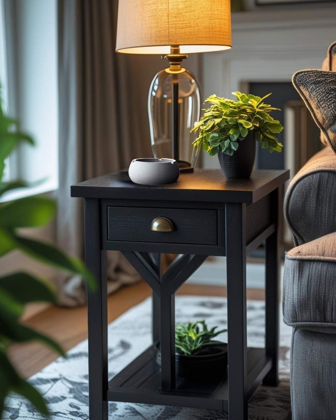 Gray concrete ashtray on an end table beside a lamp in a rustic-modern living room