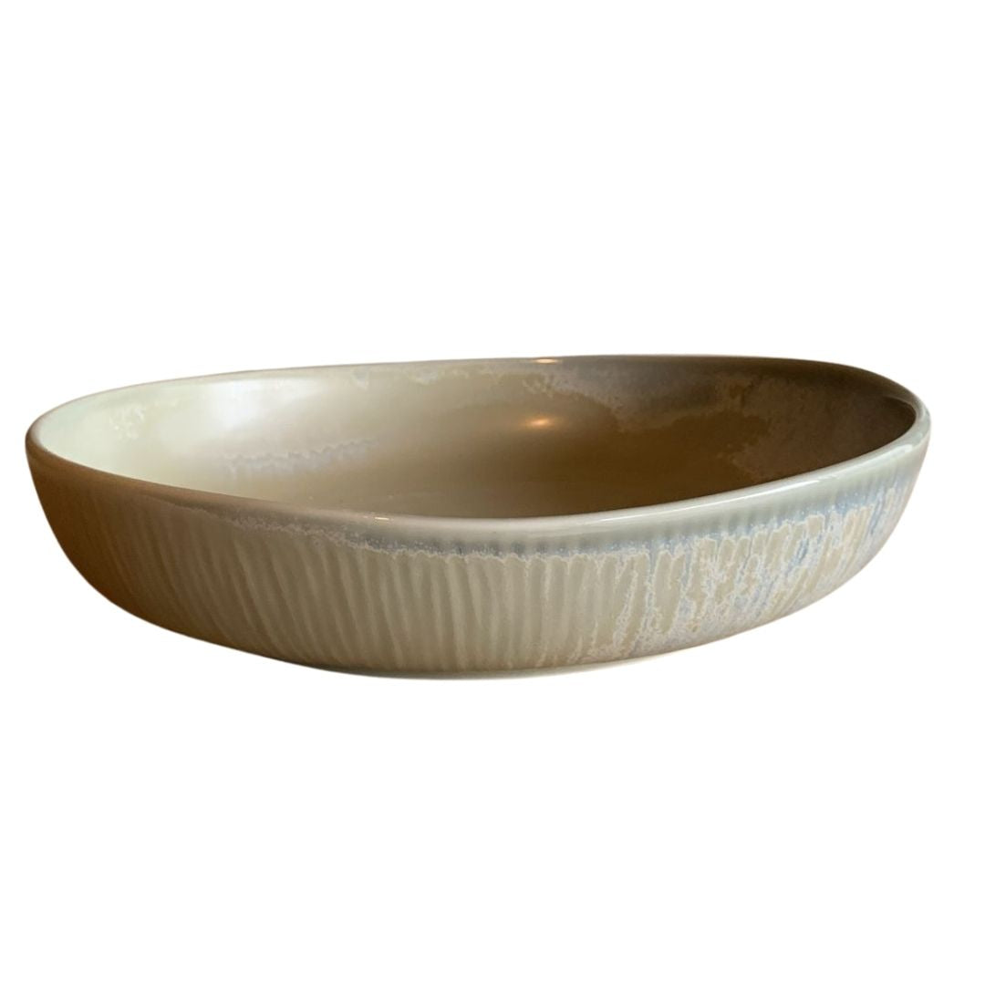 Handmade textured porcelain bowl side view on plain white background