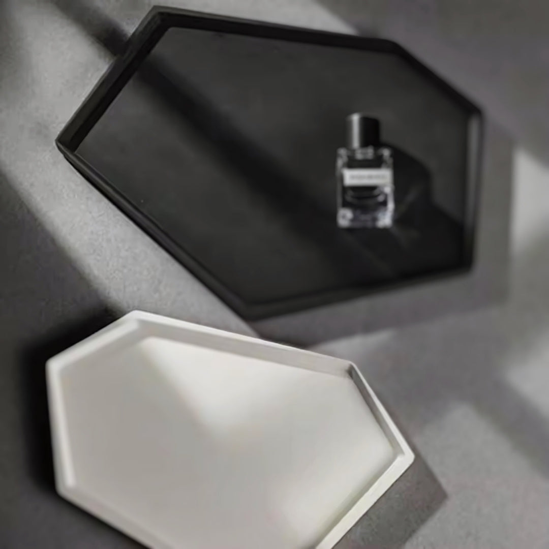 Black and white hexagonal nordic minimalist decorative trays, with a perfume bottle placed on the black tray.