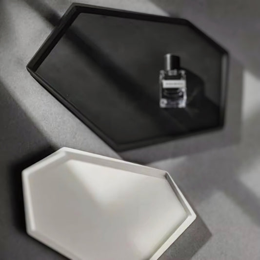 Black and white hexagonal nordic minimalist decorative trays, with a perfume bottle placed on the black tray.