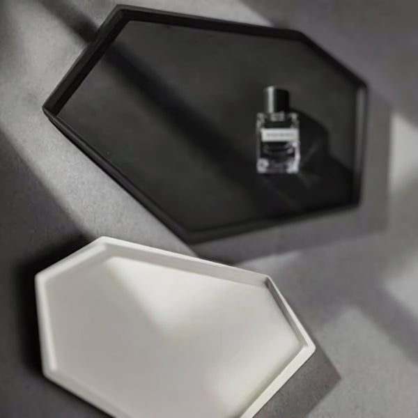 Black and white hexagonal nordic minimalist decorative trays, with a perfume bottle placed on the black tray.