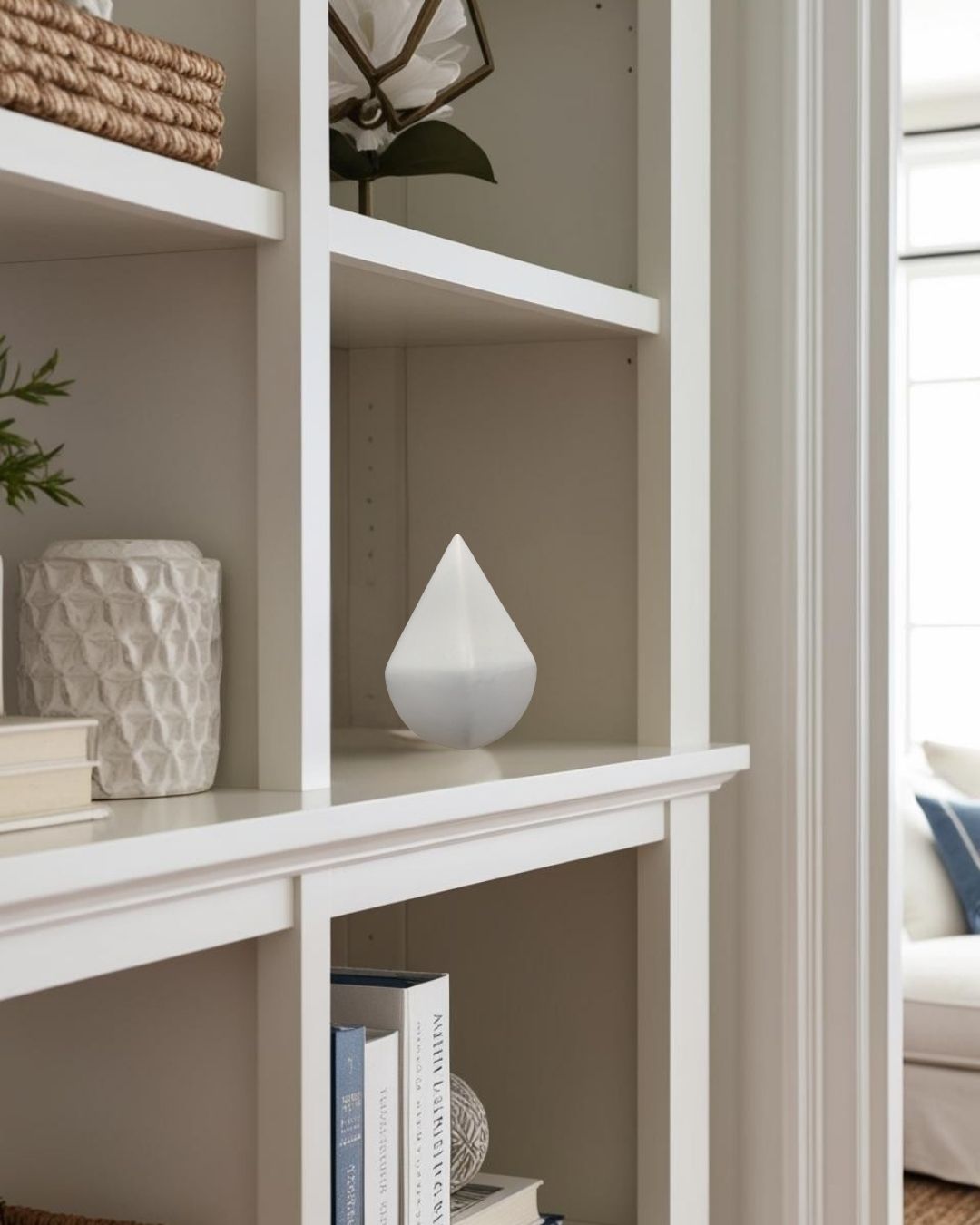Matte white accent on bookcase in a compact Scandinavian living room


