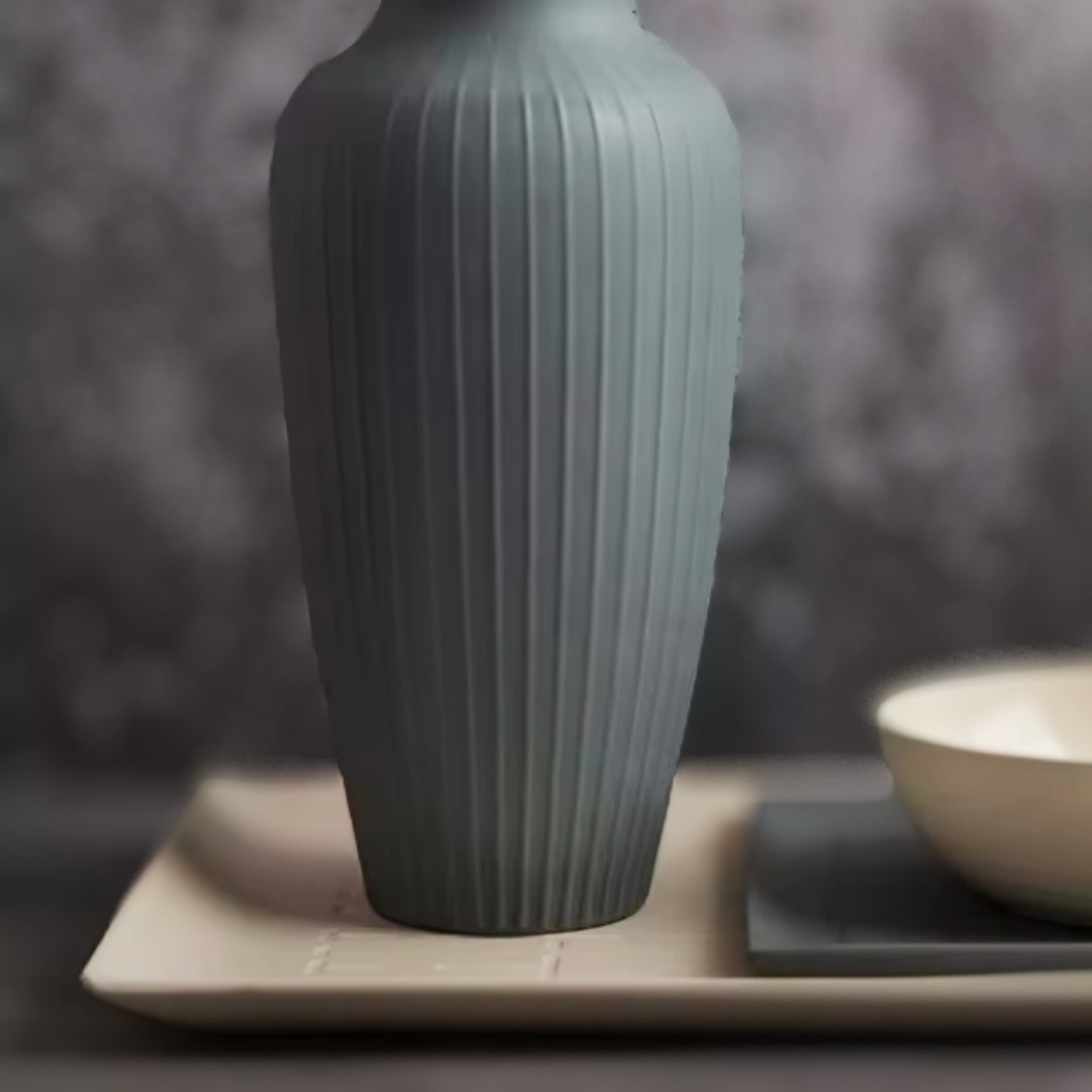 Minimalist beige ceramic tray with clean lines, displayed on a dark textured surface.