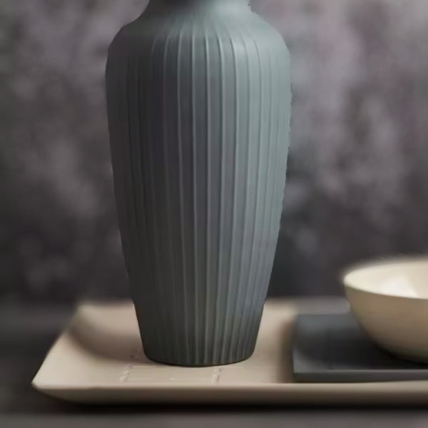 Minimalist beige ceramic tray with clean lines, displayed on a dark textured surface.