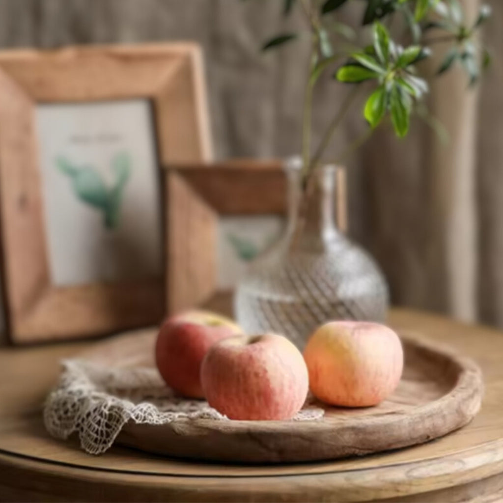 Nordic rustic circular wooden tray with a candle, lace cloth, and decorative bunny.