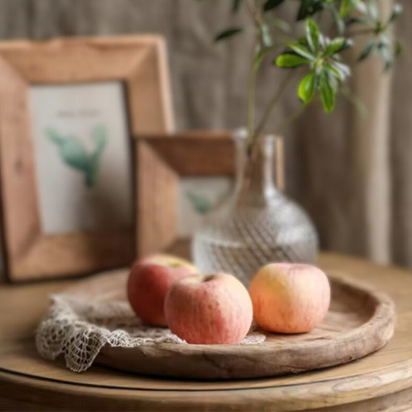 Nordic rustic circular wooden tray with a candle, lace cloth, and decorative bunny.