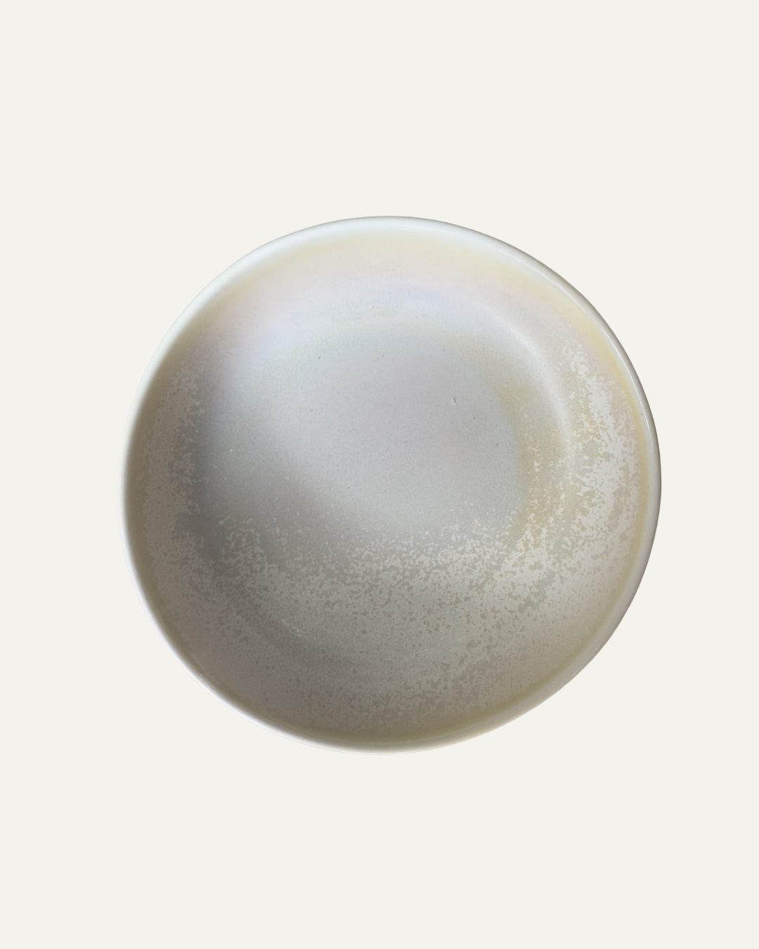 Plato hondo Rifletskal beige de porcelana con interior esmaltado en degradado, visto desde arriba sobre fondo claro.