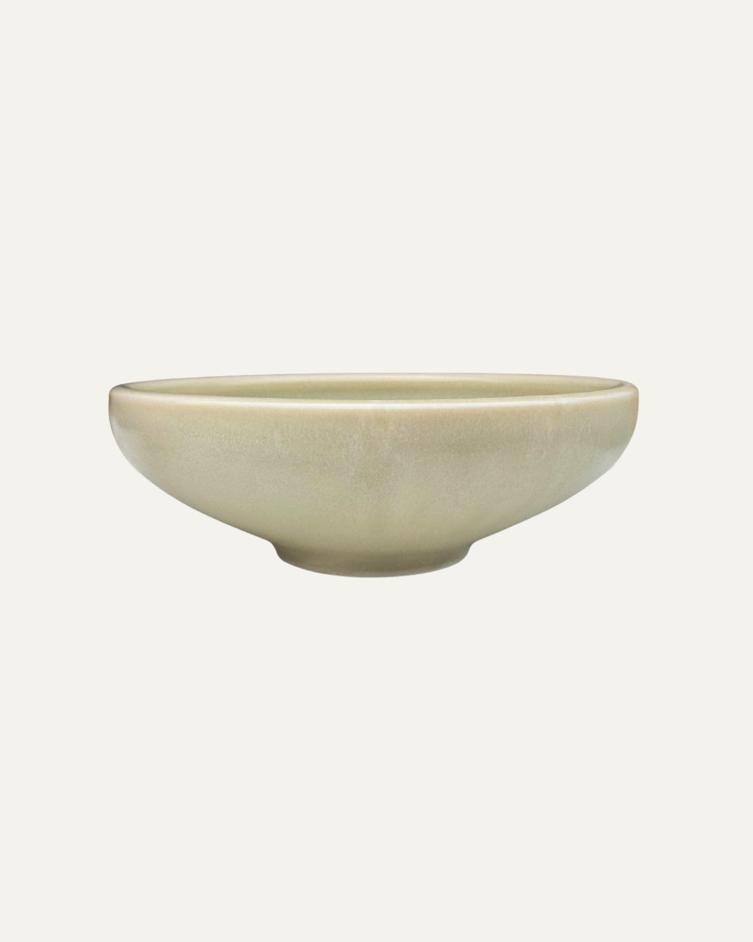 Plato hondo Traktskal beige salvia de pared curva y borde alto, con base elevada, visto de frente sobre fondo blanco.