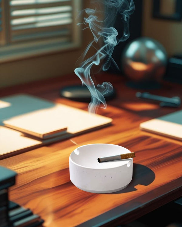 Premium white concrete decorative ashtray on a wood desk in a rustic-modern home office with warm lighting and minimalist accessories
