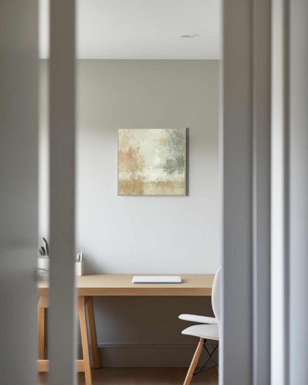  Scandinavian wall art above wooden desk in bright home office with minimalist decor
