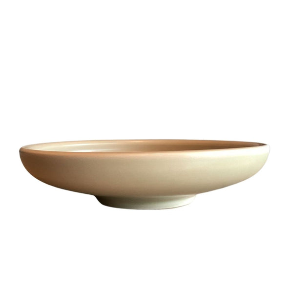 Side view of shallow beige porcelain bowl isolated on white background for product presentation