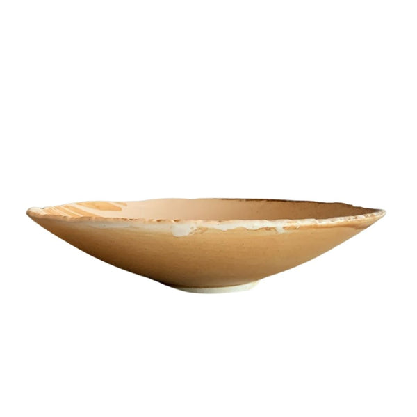 Shallow brown rustic porcelain bowl with handmade finish on white surface