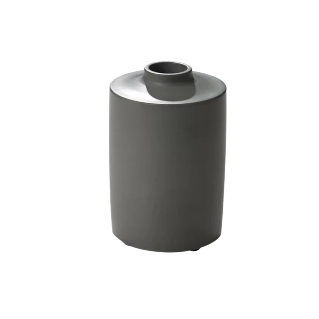 Cutout of a small round concrete vase with a smooth matte finish
