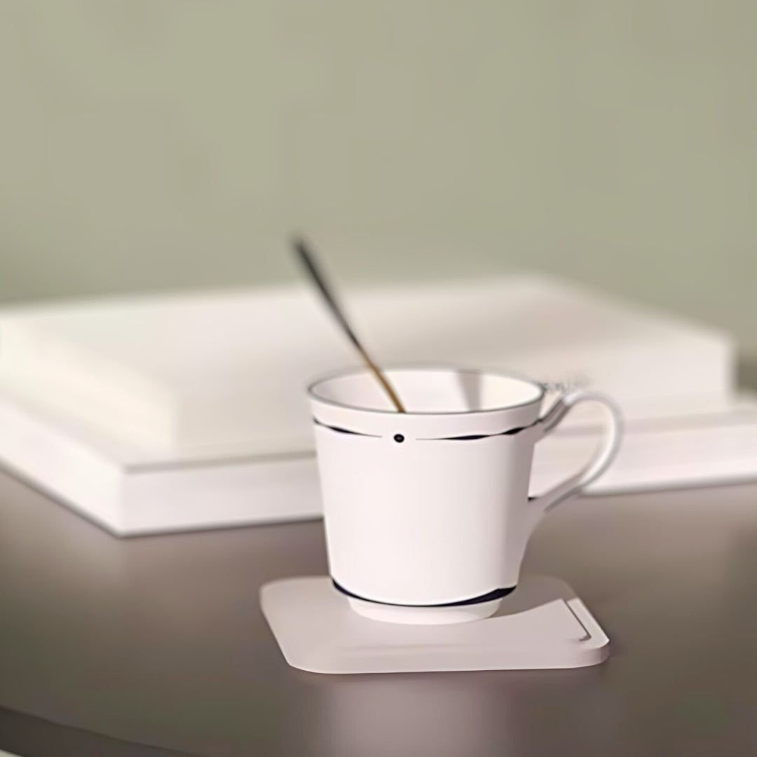 Nordmic minimalist square tray used as a cup holder, featuring a white cup with a spoon on a sleek surface.