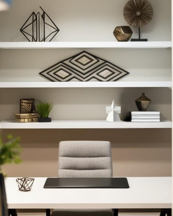 Star-shaped geometric decorative accent on white floating shelf in  home office
