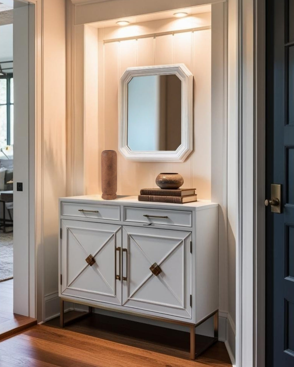Tall terracota ceramic vase on a decorative entry table with mirror in a minimalist entry