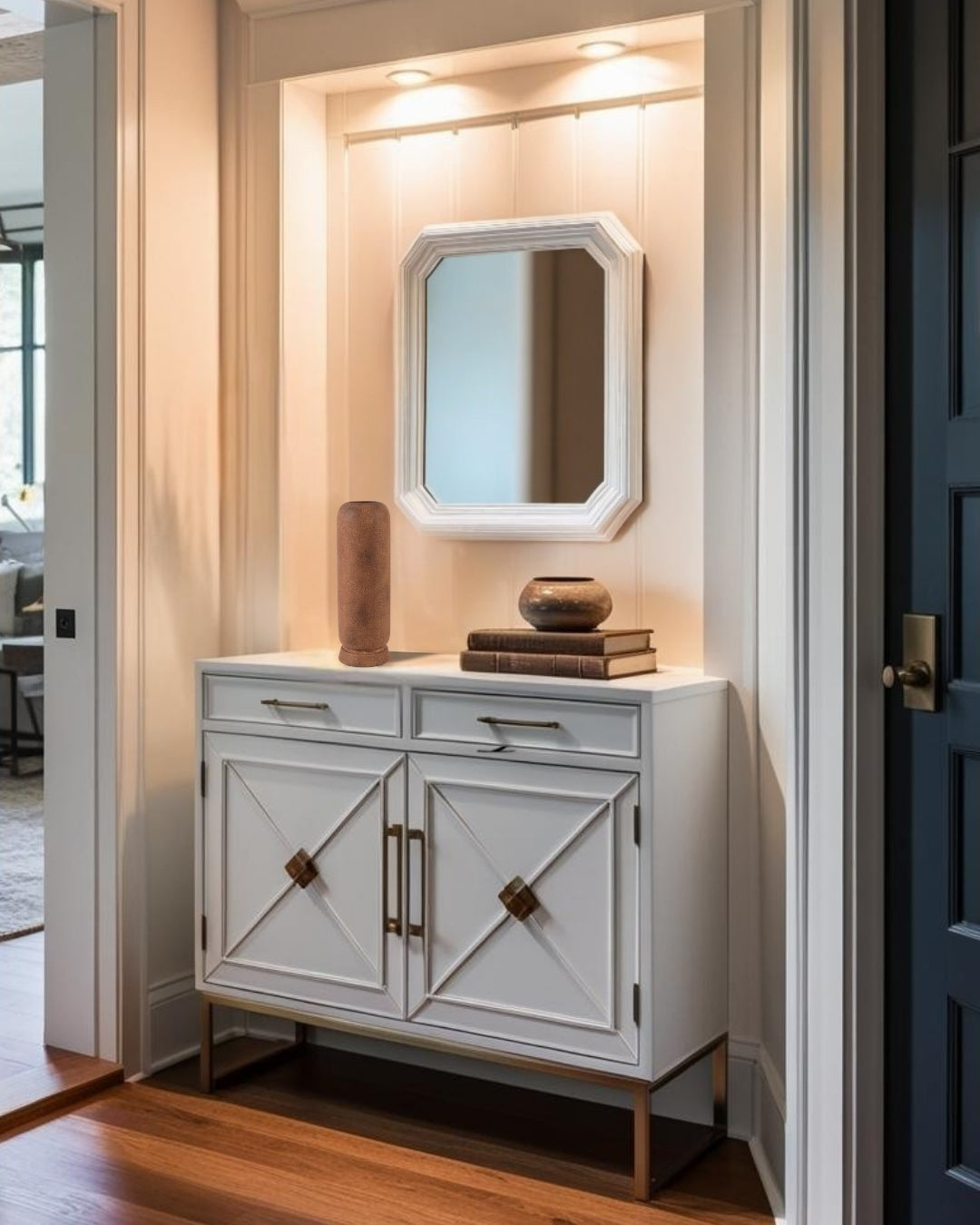 Tall terracota ceramic vase on a decorative entry table with mirror in a minimalist entry