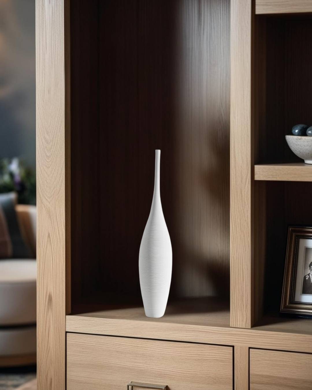 Tall white vase on bookcase in a compact traditional living room

