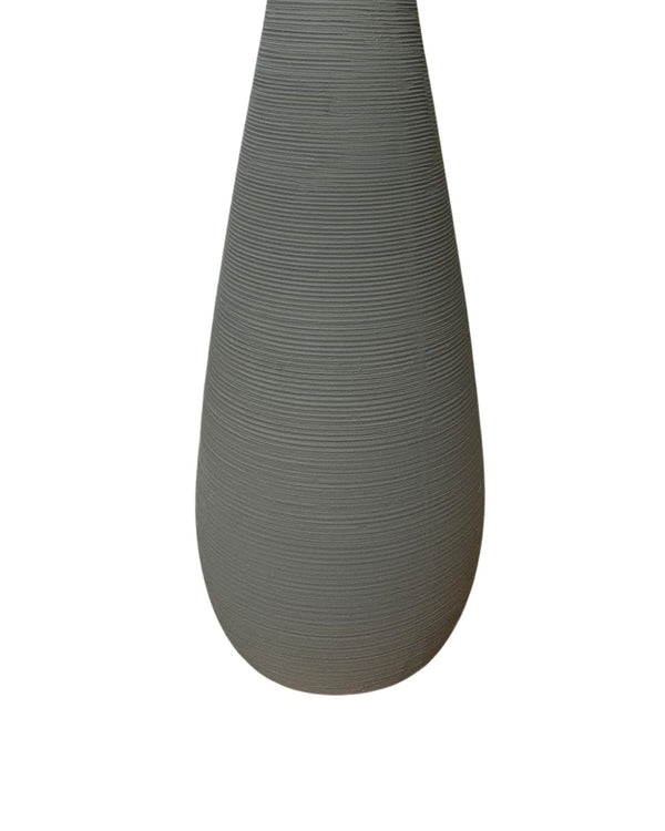 white background of a tall gray vase with textured finish and elegant silhouette

