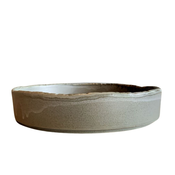 Two-tone shallow decorative porcelain bowl in beige and brown, product photo side view isolated on white background