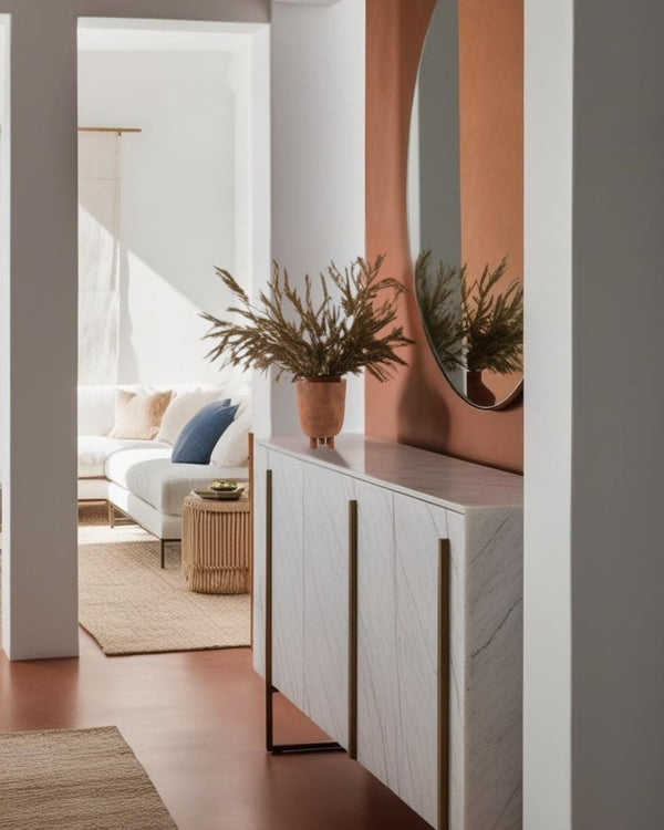 Wabi Sabi terracotta vase with dried grasses on white marble entry table in modern entryway, featuring round mirror and warm minimalist entry







