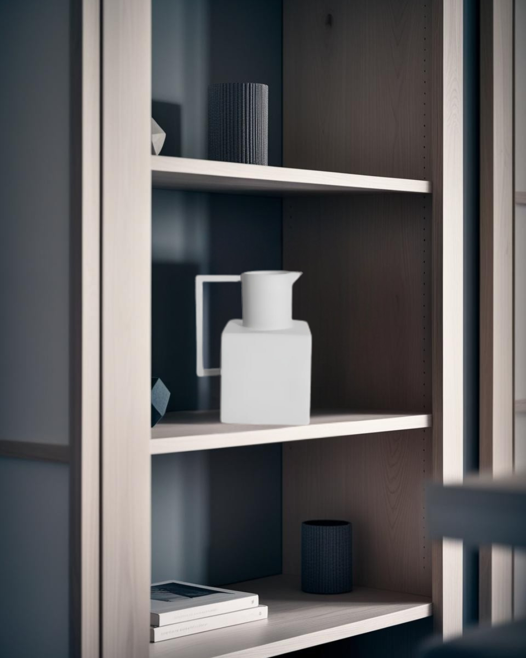 White geometric ceramic pitcher with handle on modern light wood shelf, styled with minimalist dark-toned decor accents
