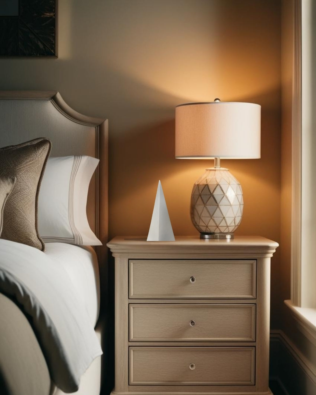  White geometric pyramid accent on nighstand in farmhouse style bedroom