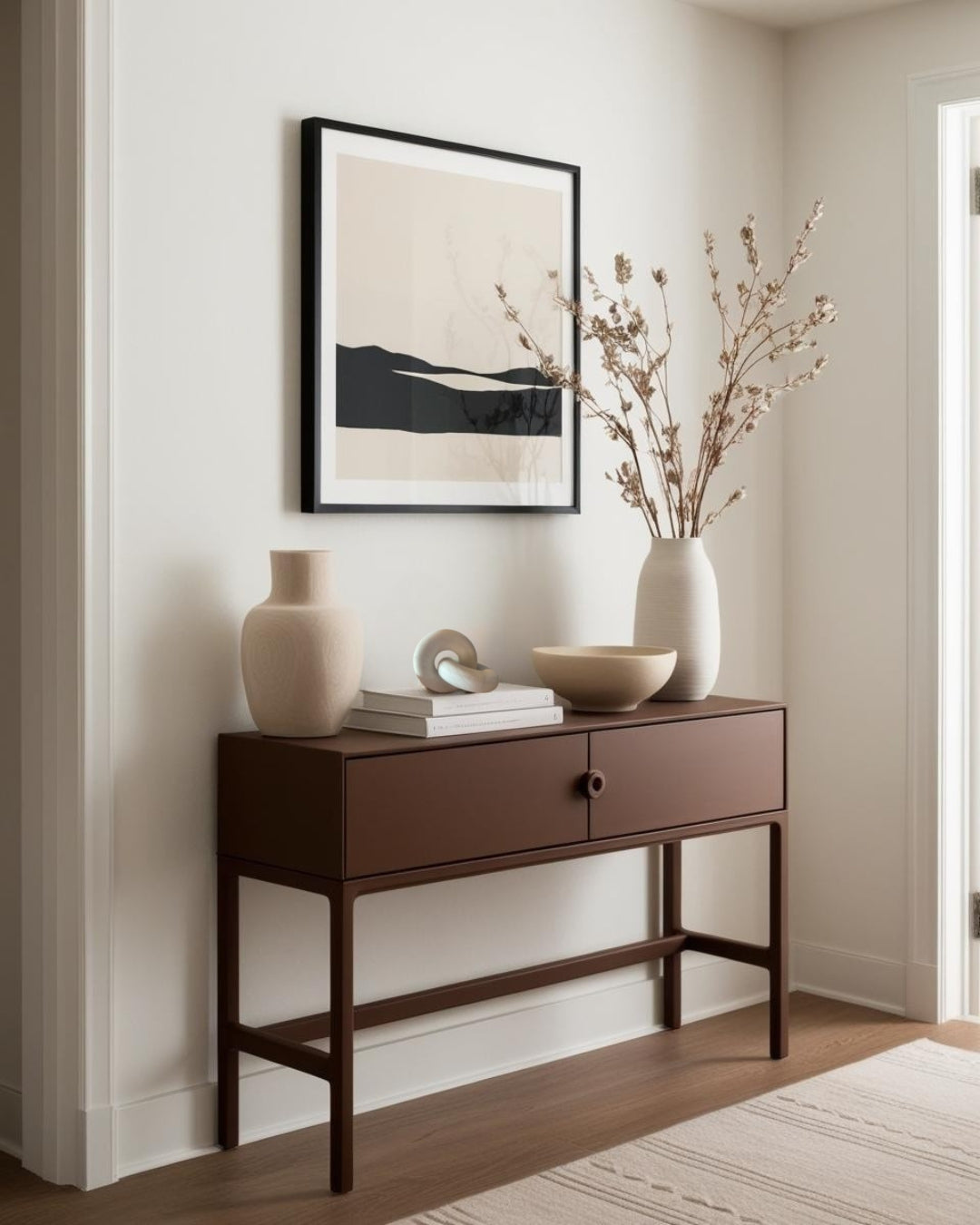 White knot-shaped sculpture on dark wood entry table in minimalist farmhouse entry