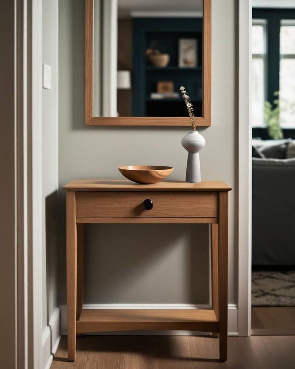 White vase on entry table in a compact Scandinavian entry in a house