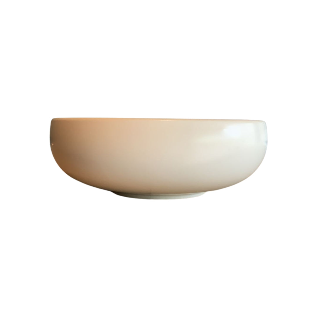 Front view of white shallow porcelain decorative bowl isolated on white background
