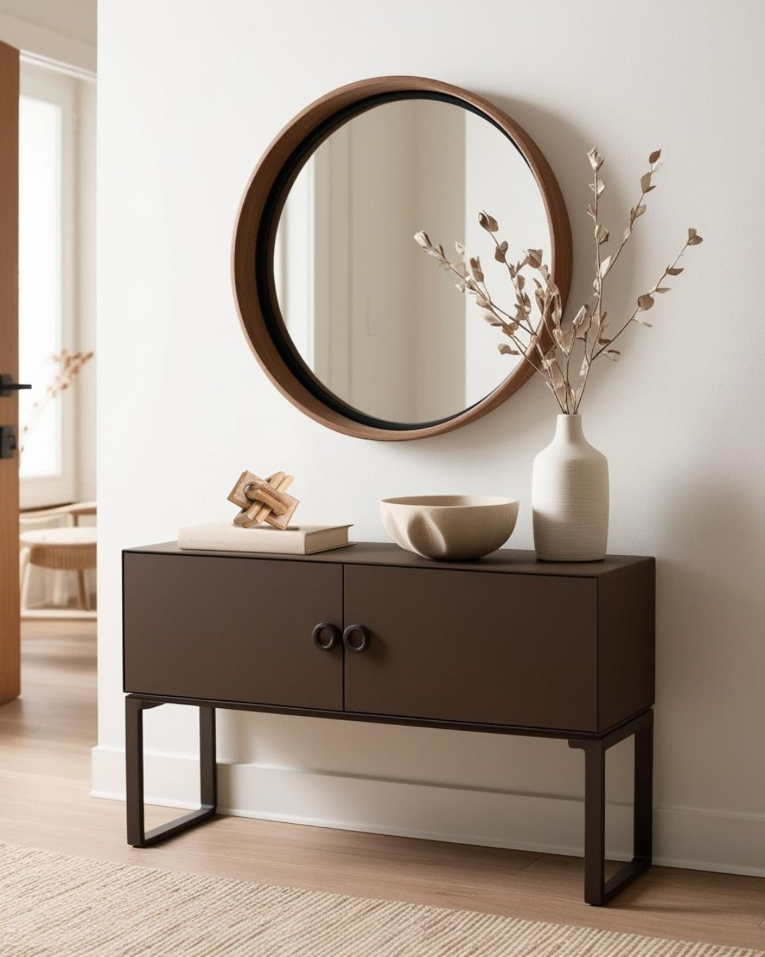 White knot accent decor on entry table table with round mirror and branches in farmhouse entry